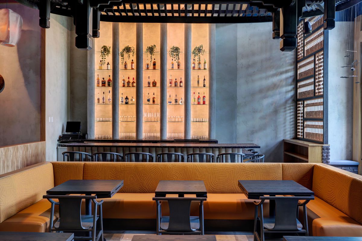 Mala Sichuan's bar area, which includes bottles of spirits lined up on backlit shelves.