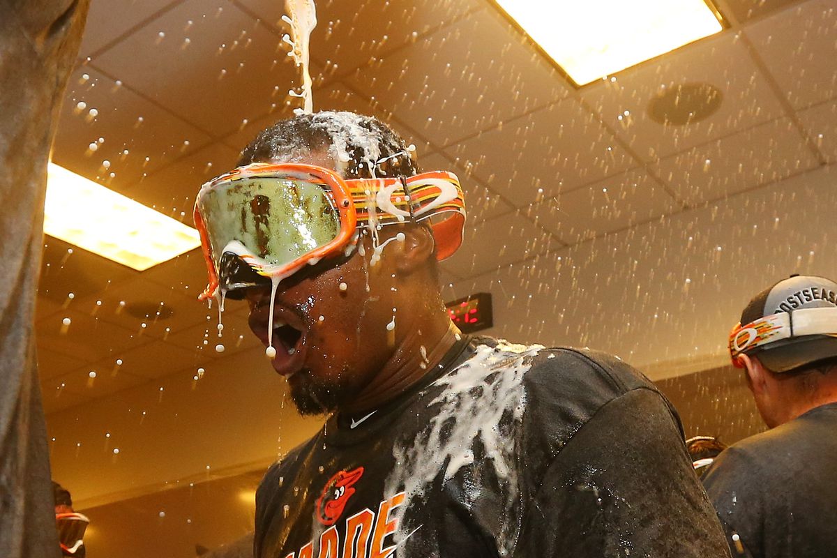 Adam Jones has beer dumped on his head as the Orioles celebrate clinching a postseason berth.