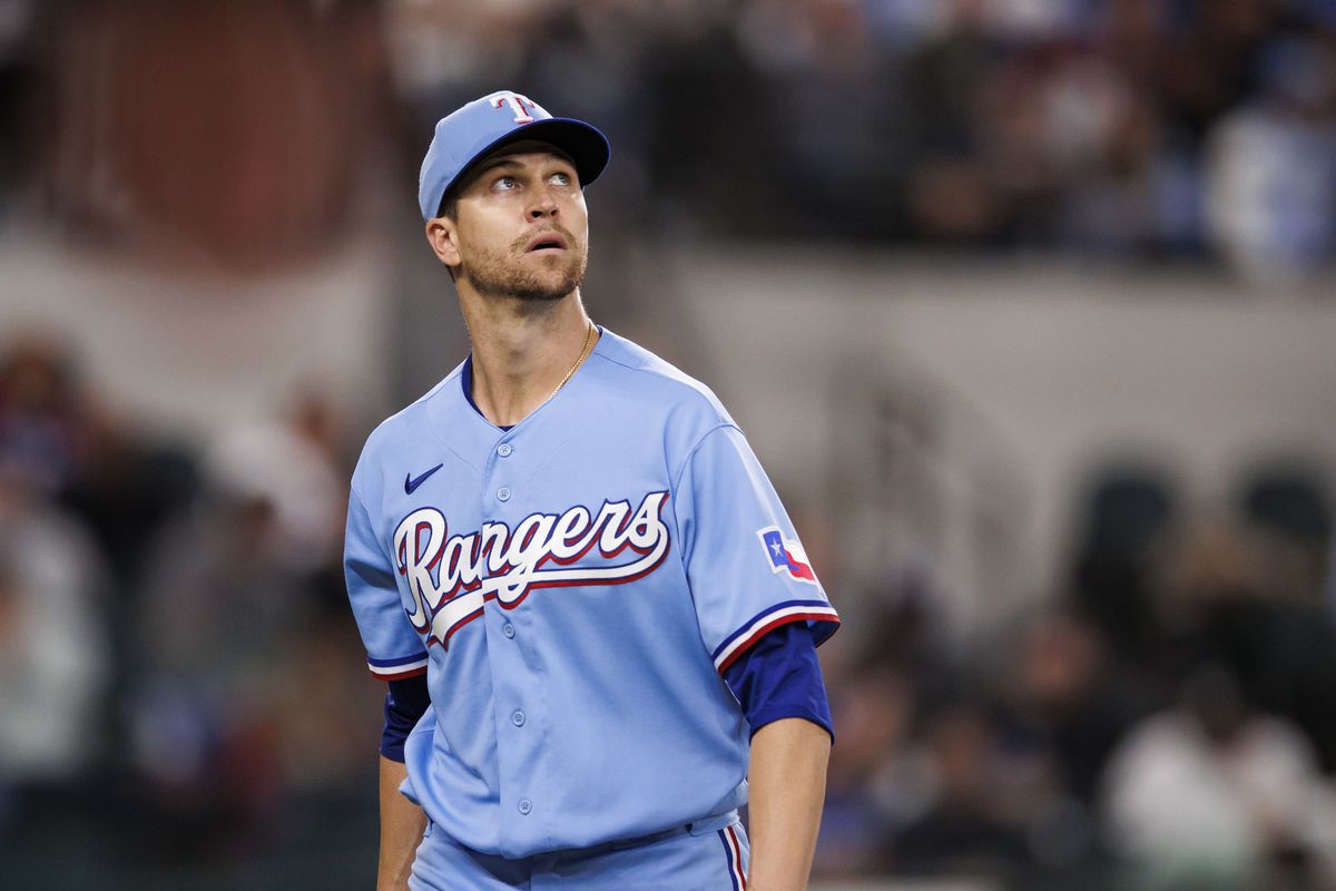 Jacob deGrom of the Texas Rangers returns to the dugout after his eleventh strikeout to end the inning during a game against the Oakland Athletics at Globe Life Field on April 23, 2023 in Arlington, Texas.