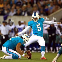 Aug 4, 2013; Canton, OH, USA; Miami Dolphins kicker Dan Carpenter (5) kicks a field goal in the second quarter of the 2013 Pro Football Hall of Fame game against the Dallas Cowboys at Fawcett Stadium.