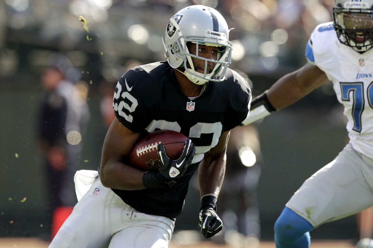 Oakland Raiders running back Taiwan Jones (22) runs the ball against the Detroit Lions in the second quarter at O.co Coliseum.