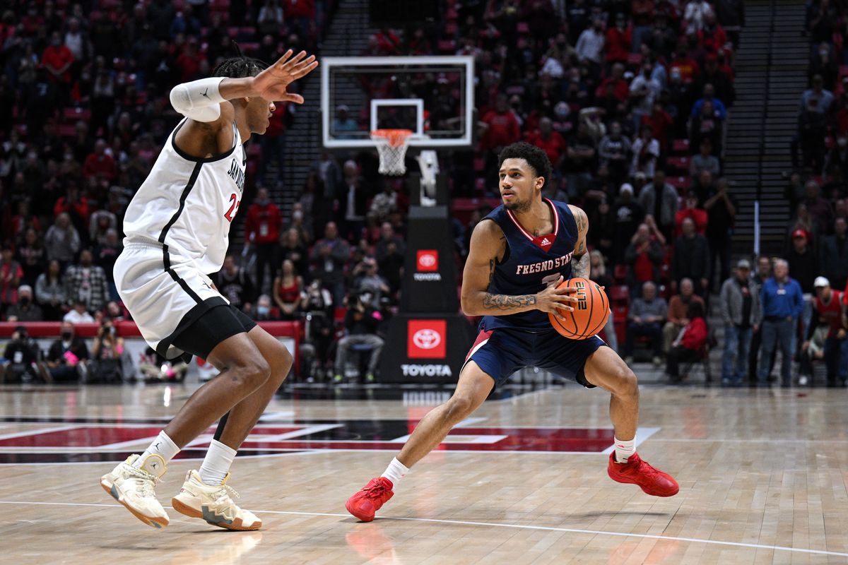 Fresno State Bulldogs guard Isaiah Hill (3) dribbles the ball while defended by San Diego State Aztecs forward Joshua Tomaic (23) during the second overtime at Viejas Arena.