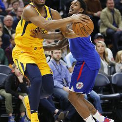 Utah Jazz guard Donovan Mitchell drives to the basket with LA Clippers guard Lou Williams defending during NBA action in Salt Lake City on Saturday, Jan. 20, 2018.