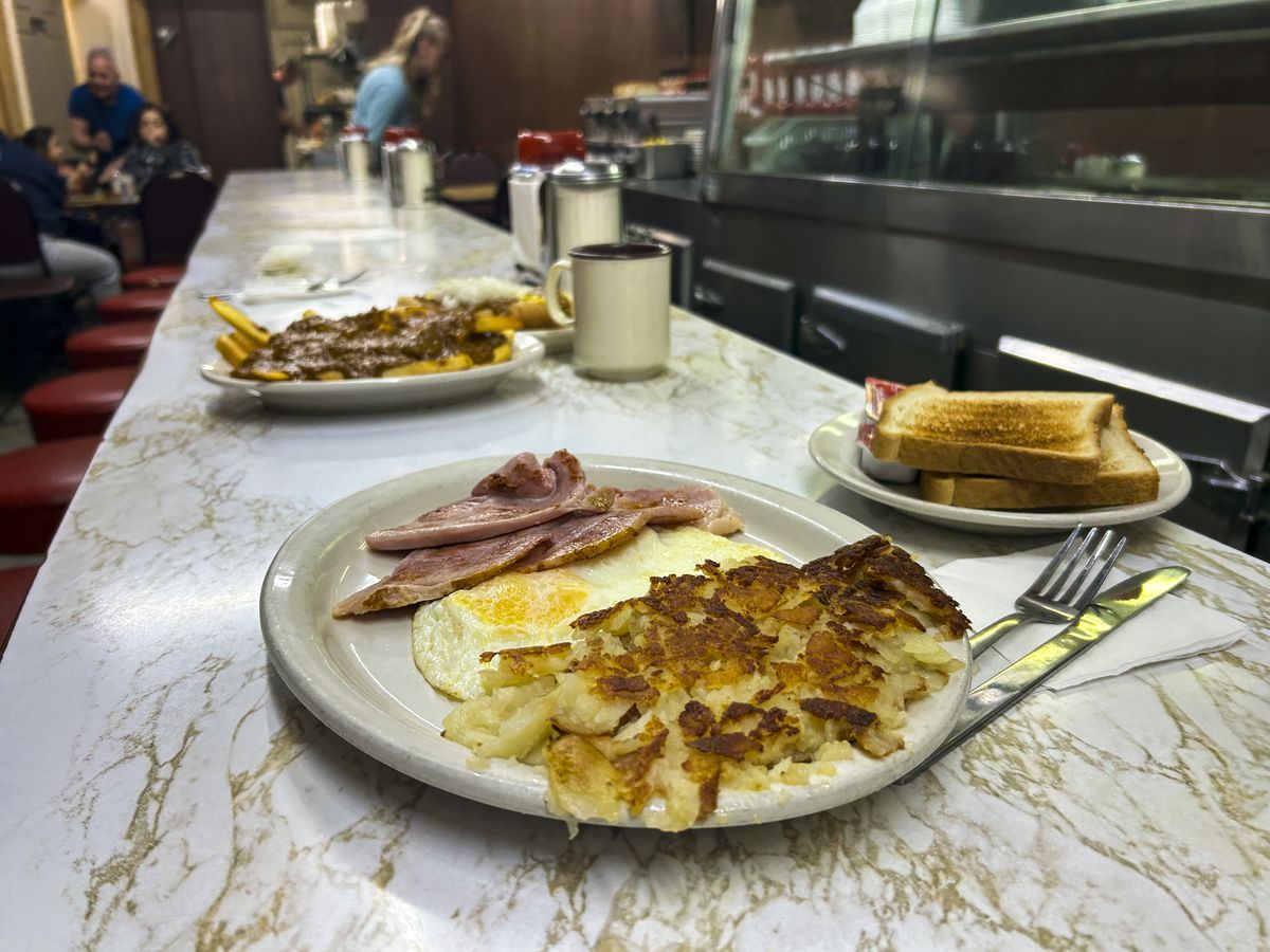 Three plates of food set on a lunch counter at Duly’s Place in Detroit, Michigan.