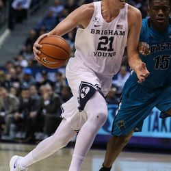 Brigham Young Cougars forward Kyle Davis (21) drives against Coastal Carolina Chanticleers forward Michel Enanga (12) during a game at the Marriott Center in Provo on Saturday, Nov. 19, 2016.