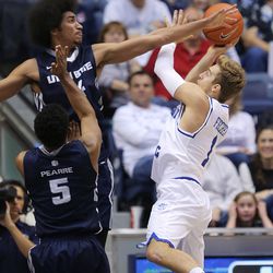 Utah State Aggies forward Jalen Moore (14) tries to defend Brigham Young Cougars guard Chase Fischer (1) as BYU and Utah State play at the Marriott Center in Provo Wednesday, Dec. 9, 2015.