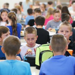 Rose Springs Elementary School students eat lunch in Stansbury Park on Wednesday, Aug. 22, 2018.
