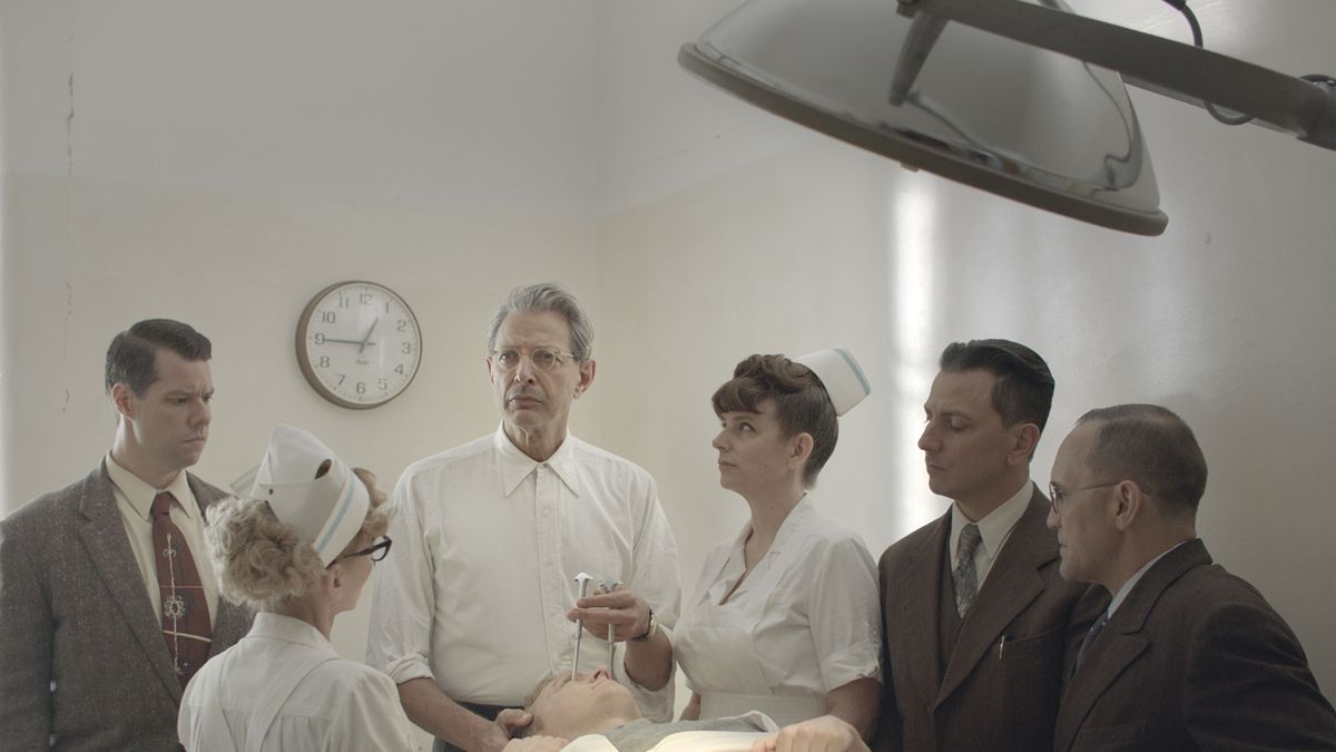 Surrounded by hospital staff, Fiennes (Jeff Goldblum) poses with an icepick held above a patient’s eye.