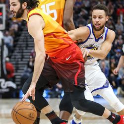 Utah Jazz guard Ricky Rubio (3) drives as forward Derrick Favors (15) sets the pick for Golden State Warriors guard Stephen Curry (30) at Vivint Arena in Salt Lake City on Tuesday, Jan. 30, 2018.