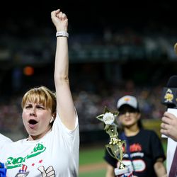 Katie Prettyman, of Marysville, Wash., celebrates her win in the women's division of a Nathan's Famous qualifier hot dog-eating contest, having eaten 14 hot dogs, at Smith's Ballpark in Salt Lake City on Tuesday, July 23, 2019. The top male and female finishers in the event qualified for a seat at the 2020 Nathan’s Famous Fourth of July International Hot Dog Eating Contest in Coney Island, New York.