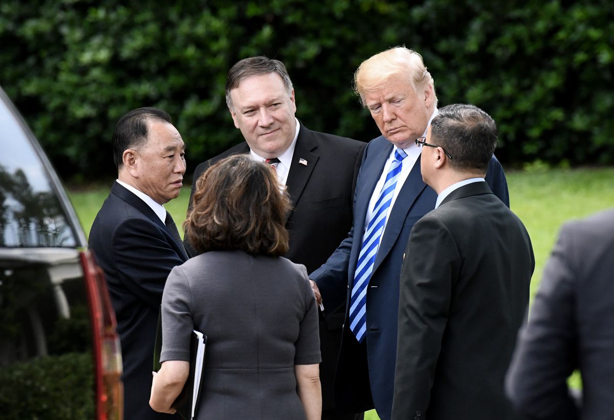 President Donald Trump speaks with Kim Yong Chol (on the left), then one of leader Kim Jong Un’s closest aides, as Secretary of State Mike Pompeo looks on outside the White House on June 1, 2018 in Washington, DC.