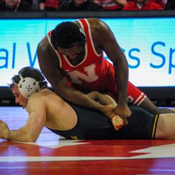 Nebraska’s Isaiah White works from top position against Michigan’s Tyler Meisinger in their 165-pound match Friday night at the Devaney Sports Center. 