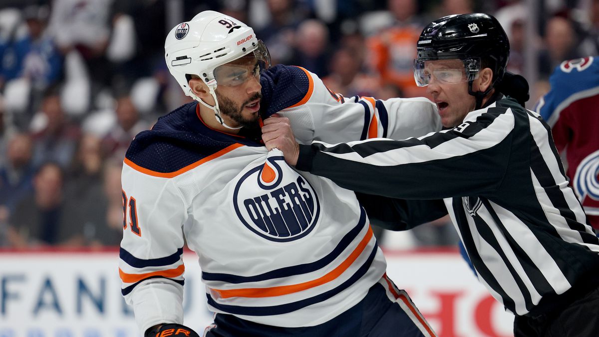 Evander Kane #91 of the Edmonton Oilers is held back by referee Dan O’Rourke #9 against the Colorado Avalanche during the first period Game Two of the Western Conference Final of the 2022 Stanley Cup Playoffs at Ball Arena on June 02, 2022 in Denver, Colorado.