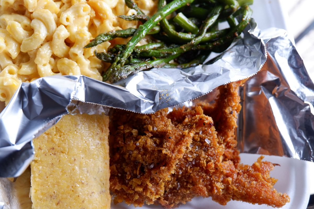 fried chicken, biscuit, mac and cheese and asparagus in takeout container