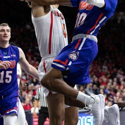 Arizona’s Chase Jeter (4) tries to stop a layup by Houston Baptist’s Braxton Bonds, right, during the Arizona-Houston Baptist game in McKale Center on November 7 in Tucson, Ariz.
