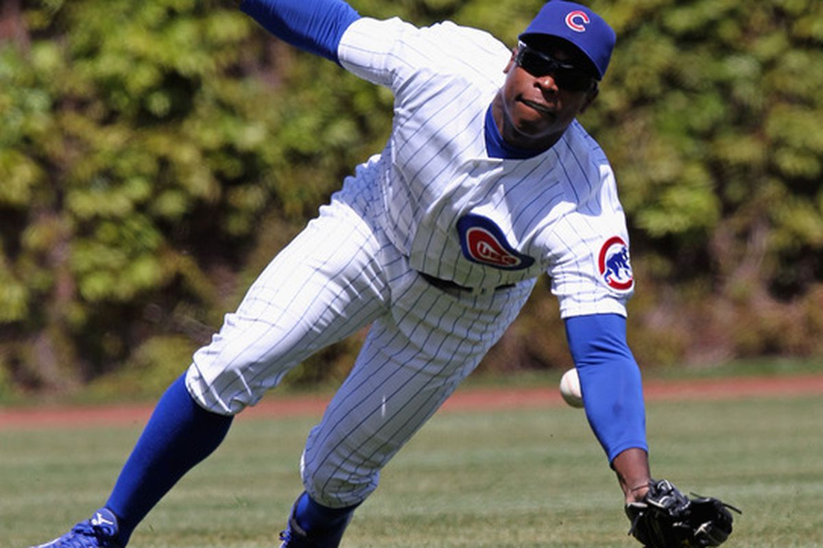 CHICAGO, IL - APRIL 22: Alfonso Soriano #12 of the Chicago Cubs misses a catch on a ball hit by Joey Votto of the Cincinnati Reds, but still managed to smile at the camera.