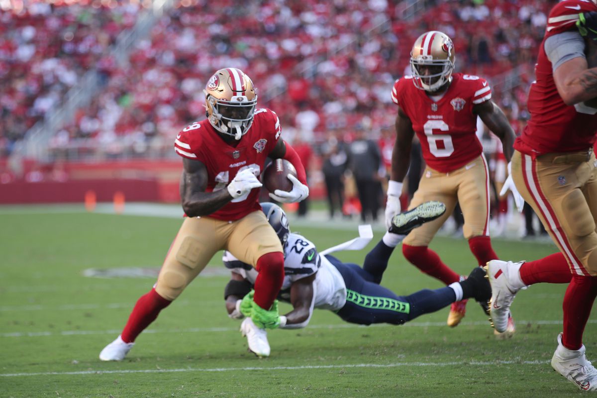 Deebo Samuel #19 of the San Francisco 49ers heads to the end zone on an 8-yard touchdown catch during the game against the Seattle Seahawks at Levi’s Stadium on October 3, 2021 in Santa Clara, California. The Seahawks defeated the 49ers 28-21.