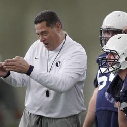 Offensive coordinator Robert Anae talks with lineman Ryan Reynolds, center, and Parker Dawe on the first day of BYU football's spring camp Monday, March 4, 2013, in Provo.