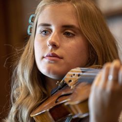 Laura Baker plays along with her mother Jenny Oaks Baker and siblings Hannah, Sarah and Matthew as they rehearse at their North Salt Lake home on Monday, Aug. 19, 2019. They are preparing to perform for President Russell M. Nelson’s 95th birthday celebration.