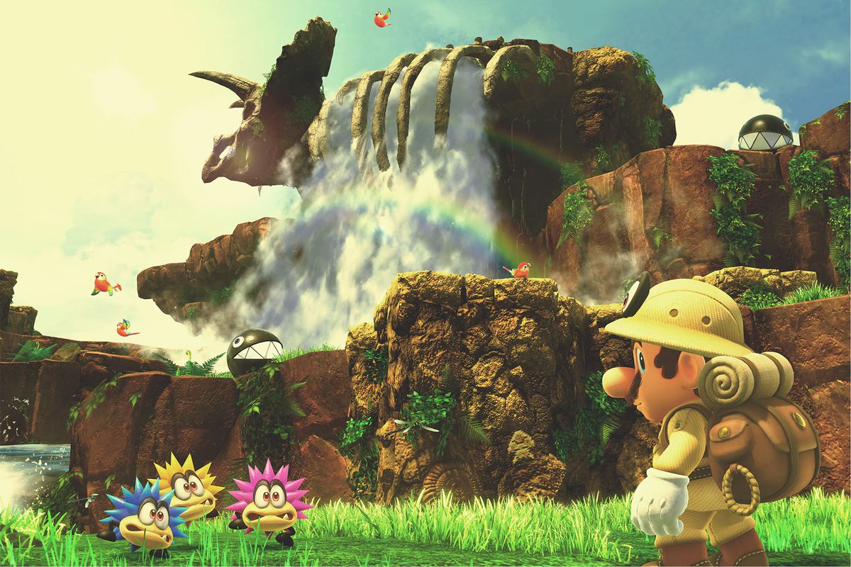 Super Mario Odyssey - Mario in nature explorer outfit standing in front of a waterfall