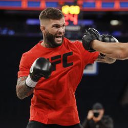 Cody Garbrandt hits pads at UFC 217 workouts.
