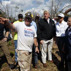President Donald Trump and first lady Melania Trump tour a neighborhood affected by Hurricane Michael, Monday, Oct. 15, 2018, in Lynn Haven, Fla. Homeland Security Secretary Kirstjen Nielsen is front right.  (AP Photo/Evan Vucci)