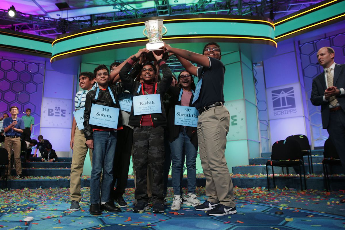 Abhijay Kodali of Flower Mound, Texas, Sohum Sukhatankar of Dallas, Texas, Rishik Gandhasri of San Jose, California, Shruthika Padhy of Cherry Hill, New Jersey, and Rohan Raja of Irving, Texas, hold up the trophy for photographers after 20 rounds of competition and won the championship of the Scripps National Spelling Bee.