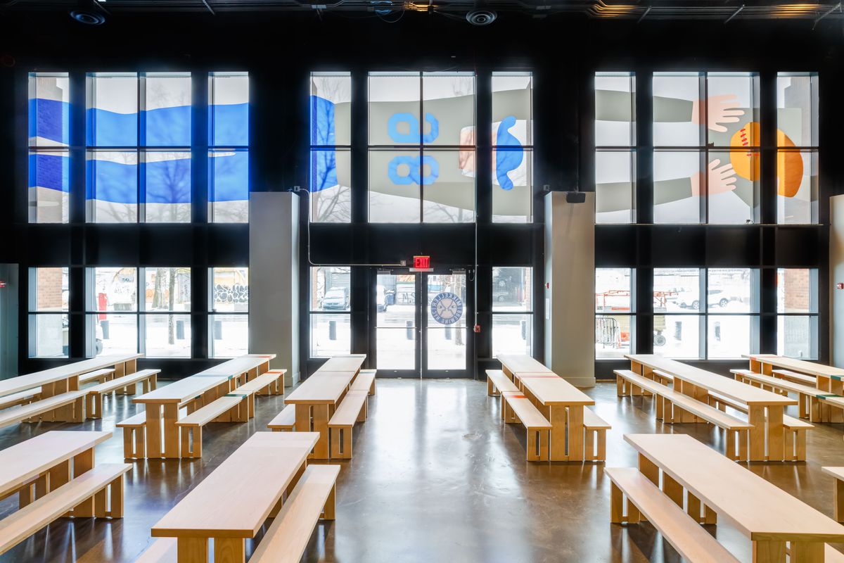 Mikkeller’s has blonde wood communal tables set in front of tall windows