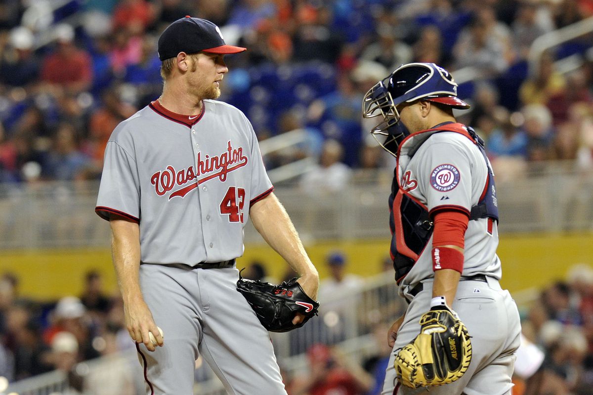 Apr 15, 2014; Miami, FL, USA; Washington Nationals starting pitcher Stephen Strasburg (left) talks with catcher Sandy Leon (right) on the pitchers mound during the first inning against the Miami Marlins at Marlins Ballpark. Mandatory Credit: Steve Mi