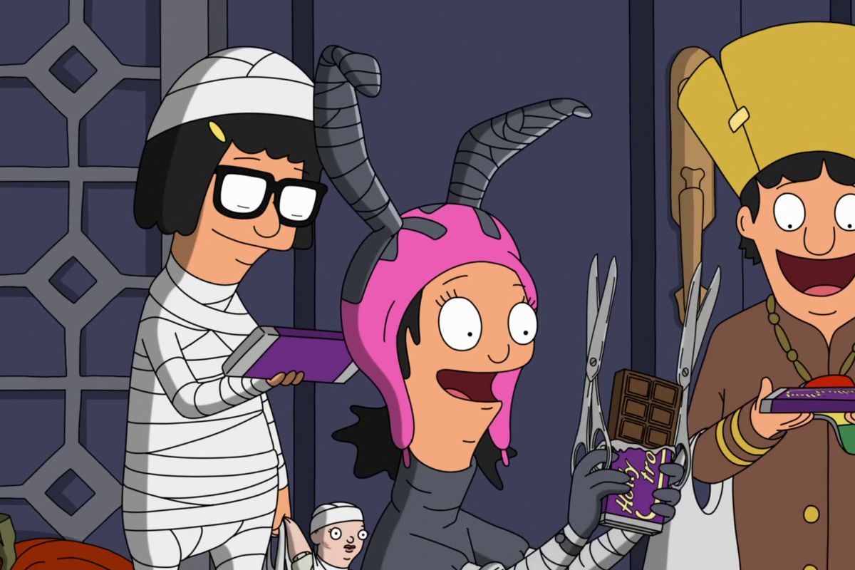 LTR, Tina (dressed as a mummy), Louise (dressed as Edward Scissorhands), and Gene (dressed as Queen Latifah) marvel at full sized candy bars in the Bob’s Burgers episode “The Hauntening.”