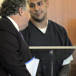 Former New England Patriots football player Aaron Hernandez, right, reacts to his attorney Michael Fee during a bail hearing in Fall River Superior Court Thursday, June 27, 2013, in Fall River, Mass. Hernandez, charged with murdering Odin Lloyd, a 27-year-old semi-pro football player, was denied bail. (AP Photo/Boston Herald, Ted Fitzgerald, Pool)