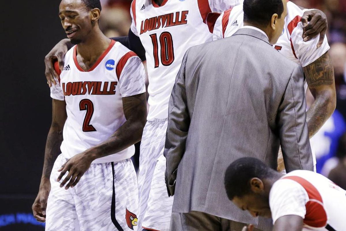 Louisville's Russ Smith (2), Gorgui Dieng (10) and Montrezl Harrell, right, react after Kevin Ware suffered a lower right leg injury during the first half of the Midwest Regional final against Duke in the NCAA tournament.