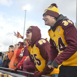 Two CMU fans cheer along with the pregame ceremonies prior to kickoff between CMU and Northern Illinois.