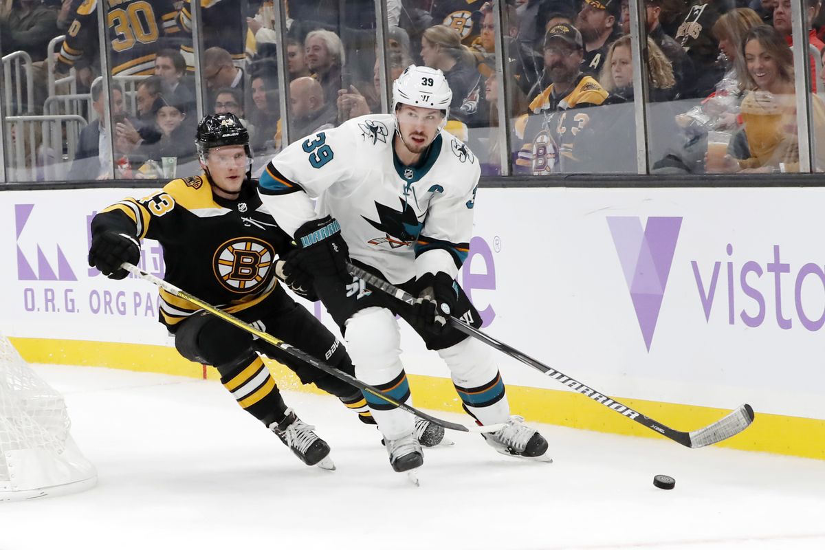 San Jose Sharks center Logan Couture (39) pressured by Boston Bruins left wing Danton Heinan (43) during a game between the Boston Bruins and the San Jose Sharks on October 29, 2019, at TD Garden in Boston, Massachusetts.