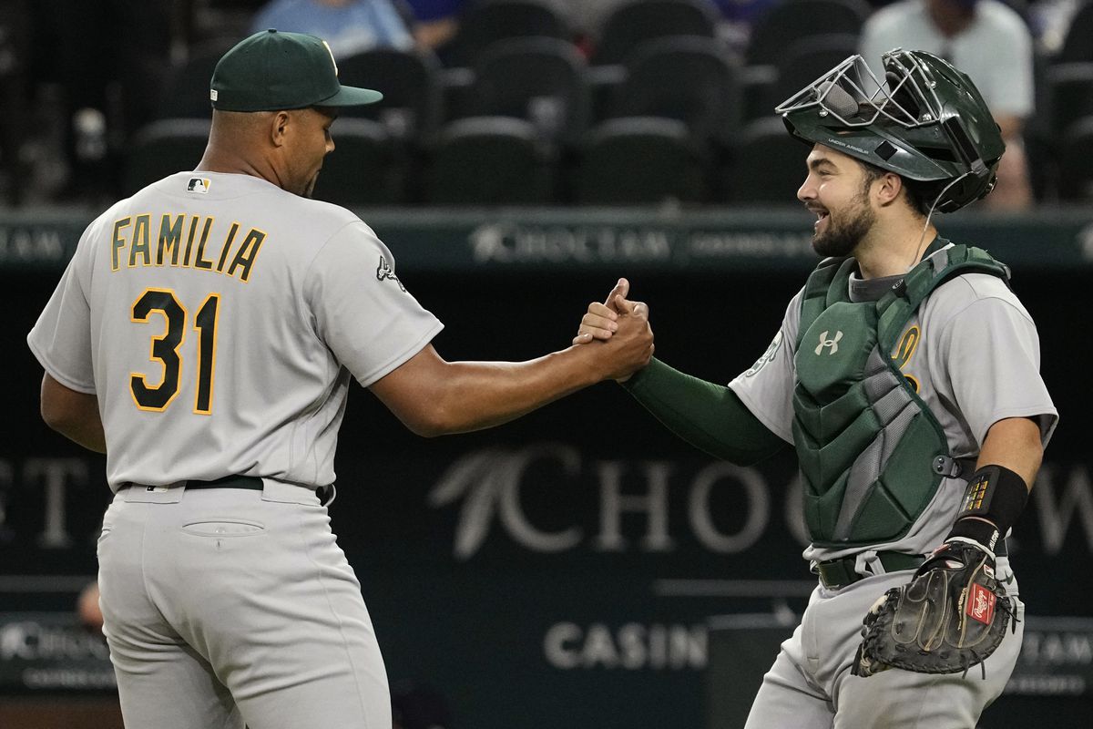 Jeurys Familia of the Oakland Athletics is congratulated by catcher Shea Langeliers after the game against the Texas Rangers at Globe Life Field on April 21, 2023 in Arlington, Texas.