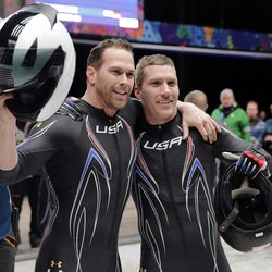 The team from the United States USA-2, piloted by Cory Butner, left, and brakeman Christopher Fogt, wave to fans after their final run during the men's two-man bobsled competition at the 2014 Winter Olympics Monday, Feb. 17, 2014, in Krasnaya Polyana, Russia.