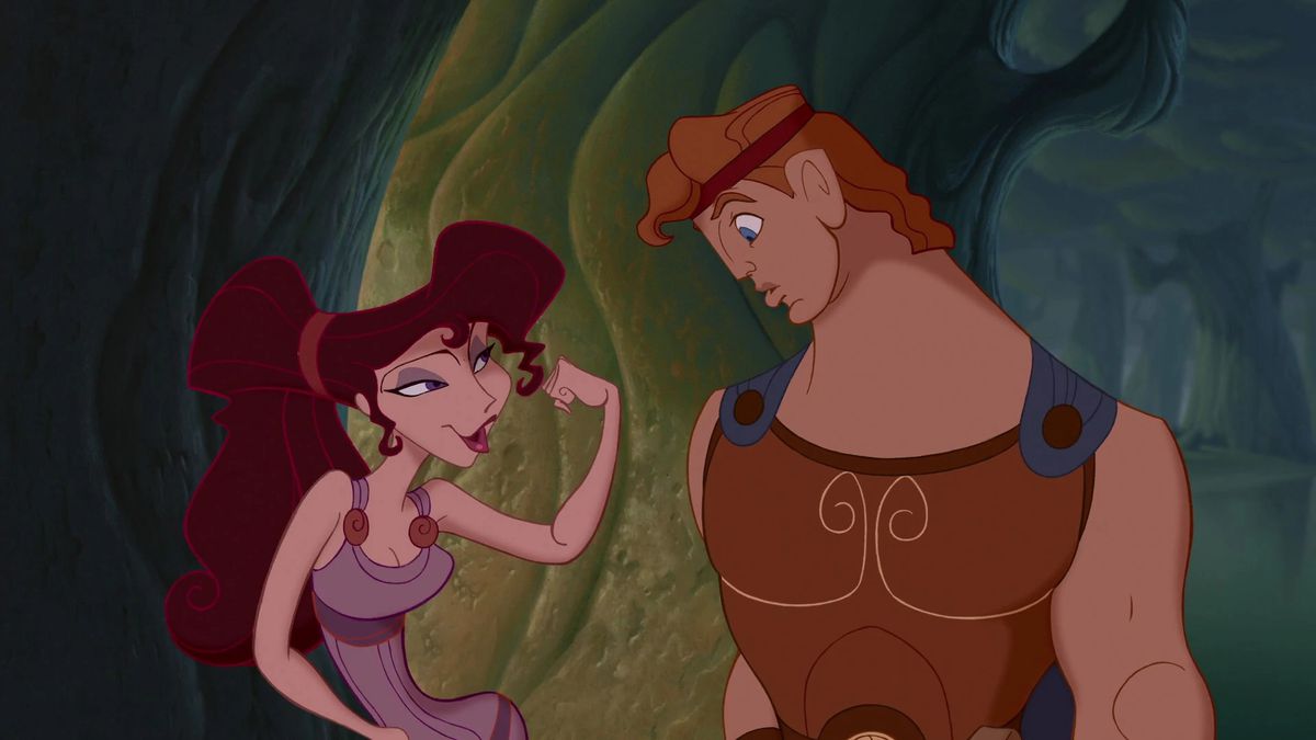 megara, a slim brunette, teases herc by flexing her muscles. hercules, a buff and strong ginger, looks at her, awestruck