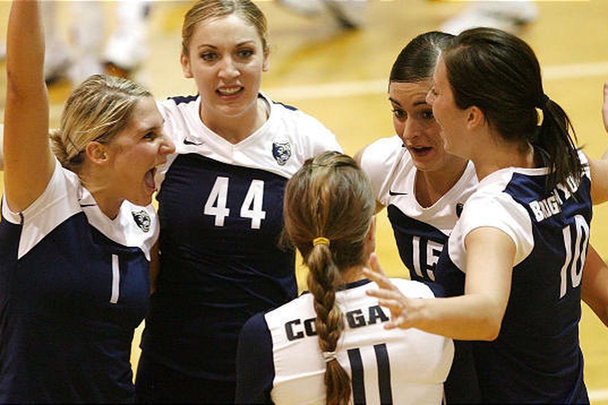BYU players celebrate a point in the first game of the Cougars' 5-game victory over Utah Friday night at Crimson Court.