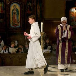 Bjorn Kierulf, eighth-grader at the Madeleine Choir School, assists Deacon Ricardo Arias during Mass on Ash Wednesday at the Cathedral of the Madeleine in Salt Lake City on Wednesday, Feb. 18, 2015.