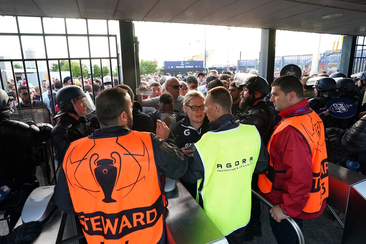 Stewards check fans tickets at turnstiles during the UEFA Champions League Final at the Stade de France, Paris. Picture date: Saturday May 28, 2022.