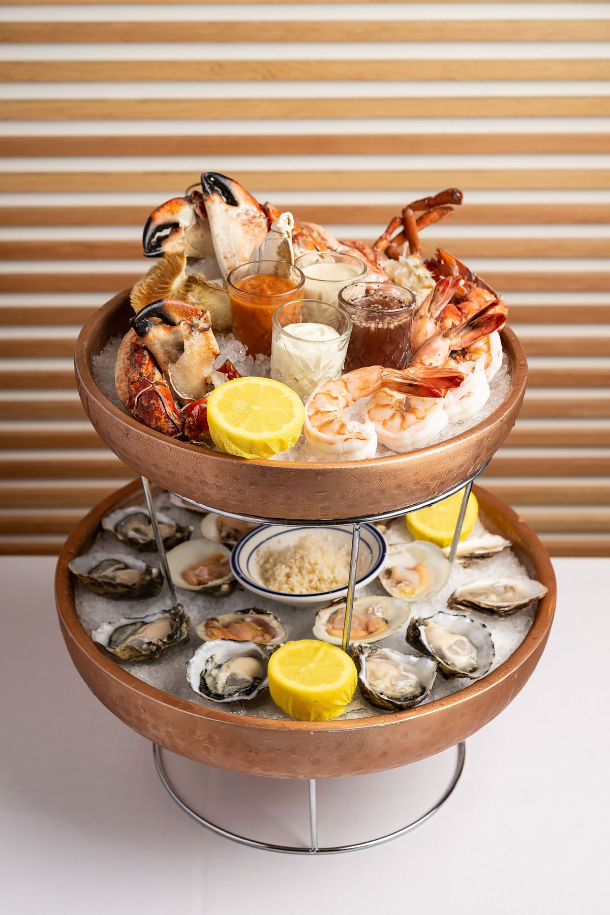 A two-tired seafood tower with raw oysters, shrimp, lobster, and crab claws at Dear Jane’s.
