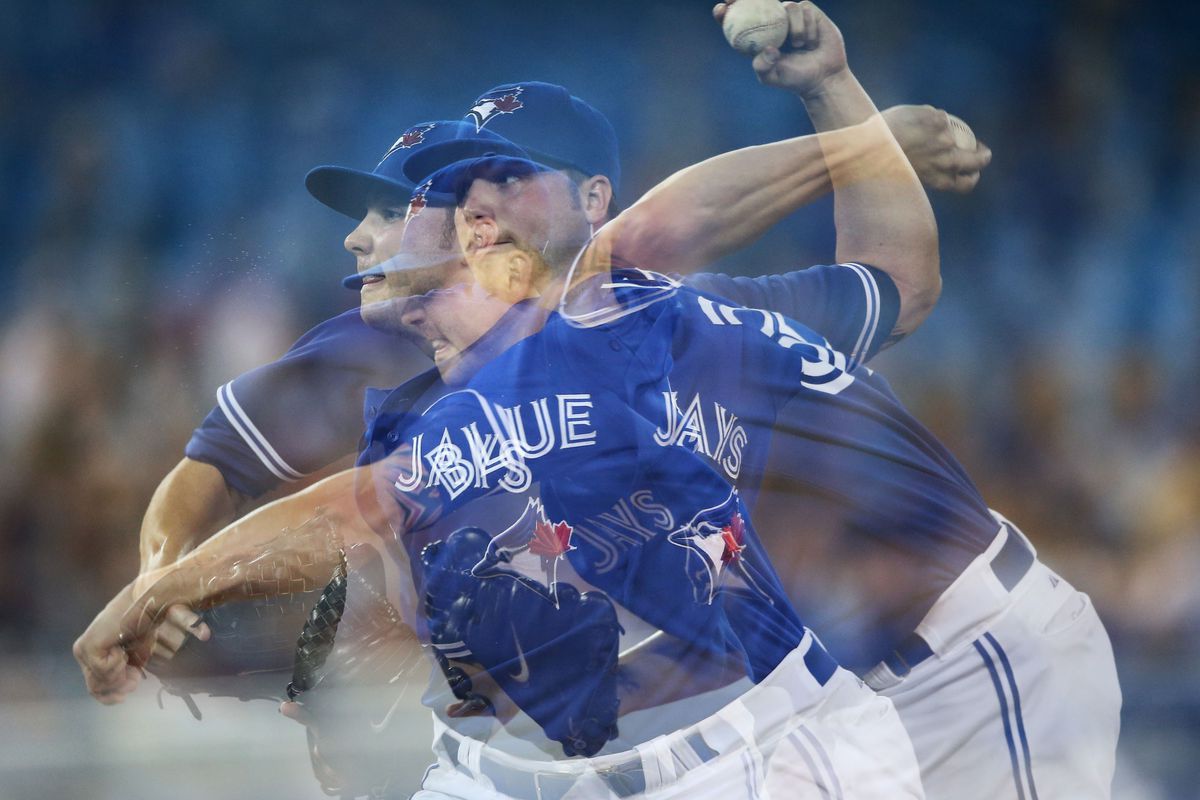 Jul 26, 2012; Toronto, ON, Canada; A multiple exposure shot of Toronto Blue Jays starting pitcher Aaron Laffey (32) delivers a pitch against the Oakland Athletics at the Rogers Centre. Mandatory Credit: Tom Szczerbowski-US PRESSWIRE