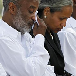 Haiti's President Rene Preval, left, wipes tears from his face during a national day of mourning as he sits with his wife Elisabeth Debrosse Preval in Port-au-Prince, Friday.