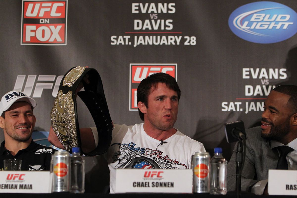 Chael Sonnen holds up his replica UFC championship belt and plays to the crowd at the UFC on FOX 2 pre-fight press conference on Jan. 26, 2012, in Chicago, Illinois. 