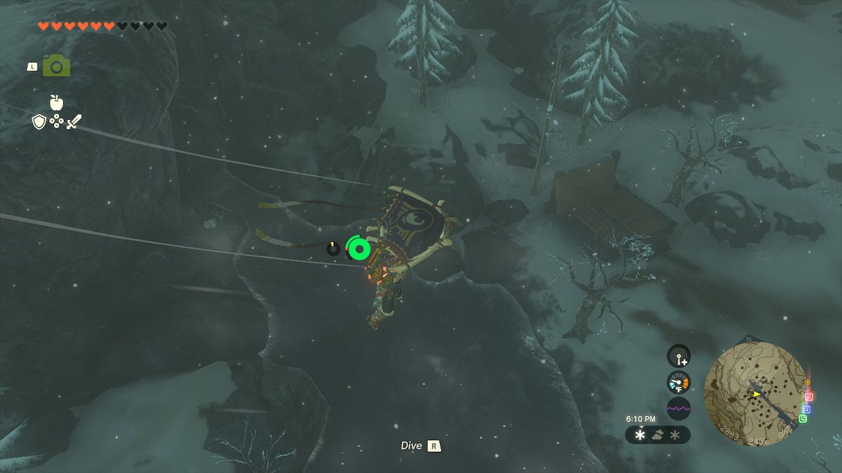 Link paraglides to the entrance of the Hebra Headspring Cave in Zelda: Tears of the Kingdom