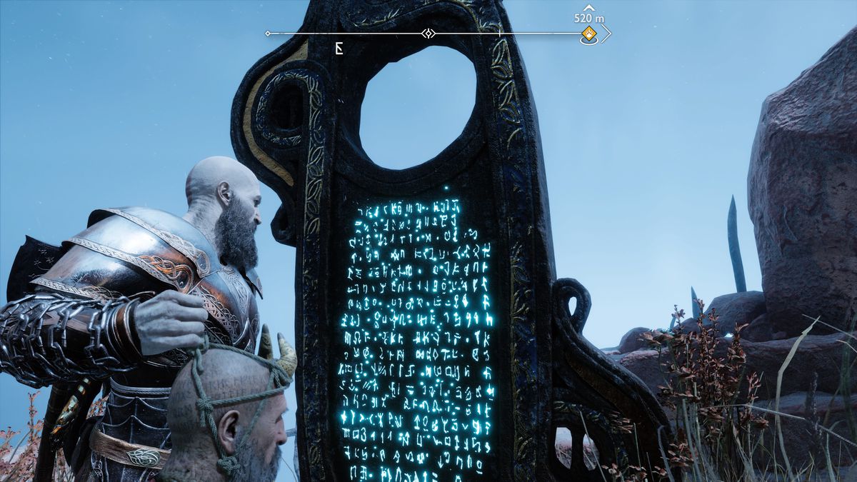 Kratos reads lore off of a tablet in God of War Ragnarok