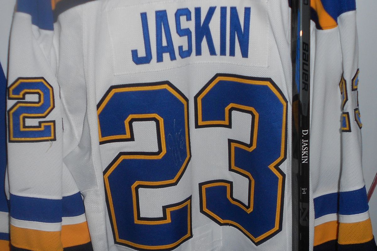 Game worn 2015 game worn Blues jersey signed by Dmitrij Jaskin, who scored the game winning goal in game five.
