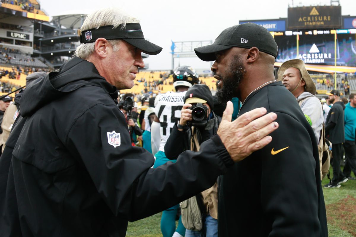 Head Coach Doug Pederson of the Jacksonville Jaguars talks with Head Coach Mike Tomlin of the Pittsburgh Steelers after the game at Acrisure Stadium on October 29, 2023 in Pittsburgh, Pennsylvania.