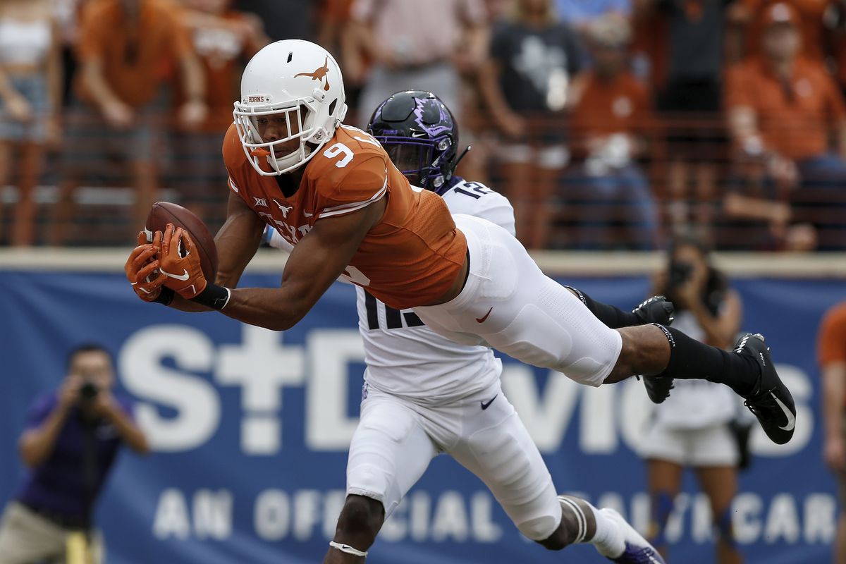 Collin Johnson #9 of the Texas Longhorns catches a pass for a touchdown defended by Jeff Gladney #12 of the TCU Horned Frogs in the third quarter at Darrell K Royal-Texas Memorial Stadium on September 22, 2018 in Austin, Texas.