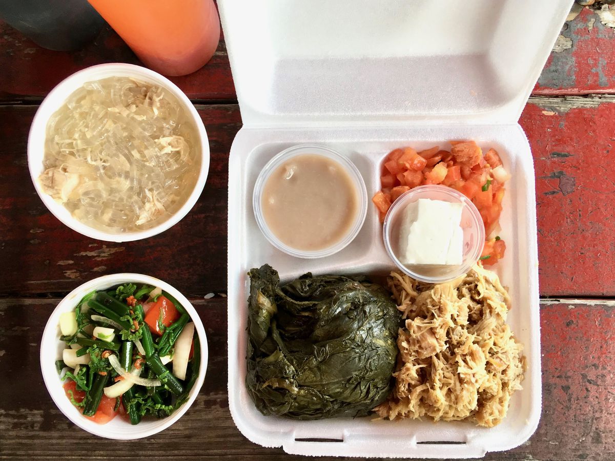 A takeout container with a variety of dishes